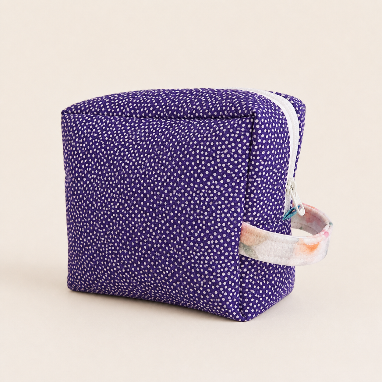 Purple handmade cosmetic pouch on a clean studio background.